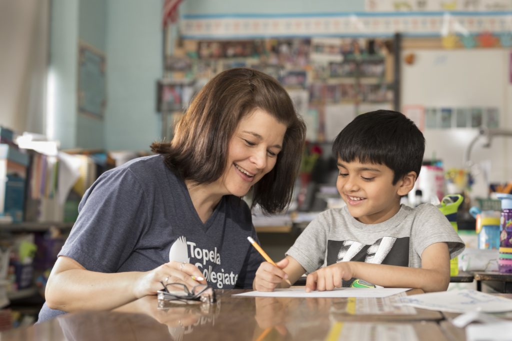 Topeka Collegiate teacher helping a student